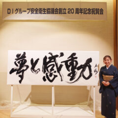 書家・根本みきが「DIグループ安全衛生協議会 創立20周年記念祝賀会」で、DIグループ代表・小板橋社長のモットー「夢と感動」を力強く揮毫する書道パフォーマンスを披露。参加者の夢が実り、感動が広がるよう願いを込めた作品。